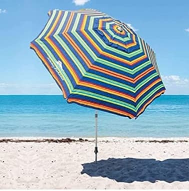Multicolor beach umbrella casting shade on tropical shoreline scene
