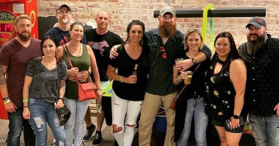 Group of people inside axe-throwing bar enjoying social event