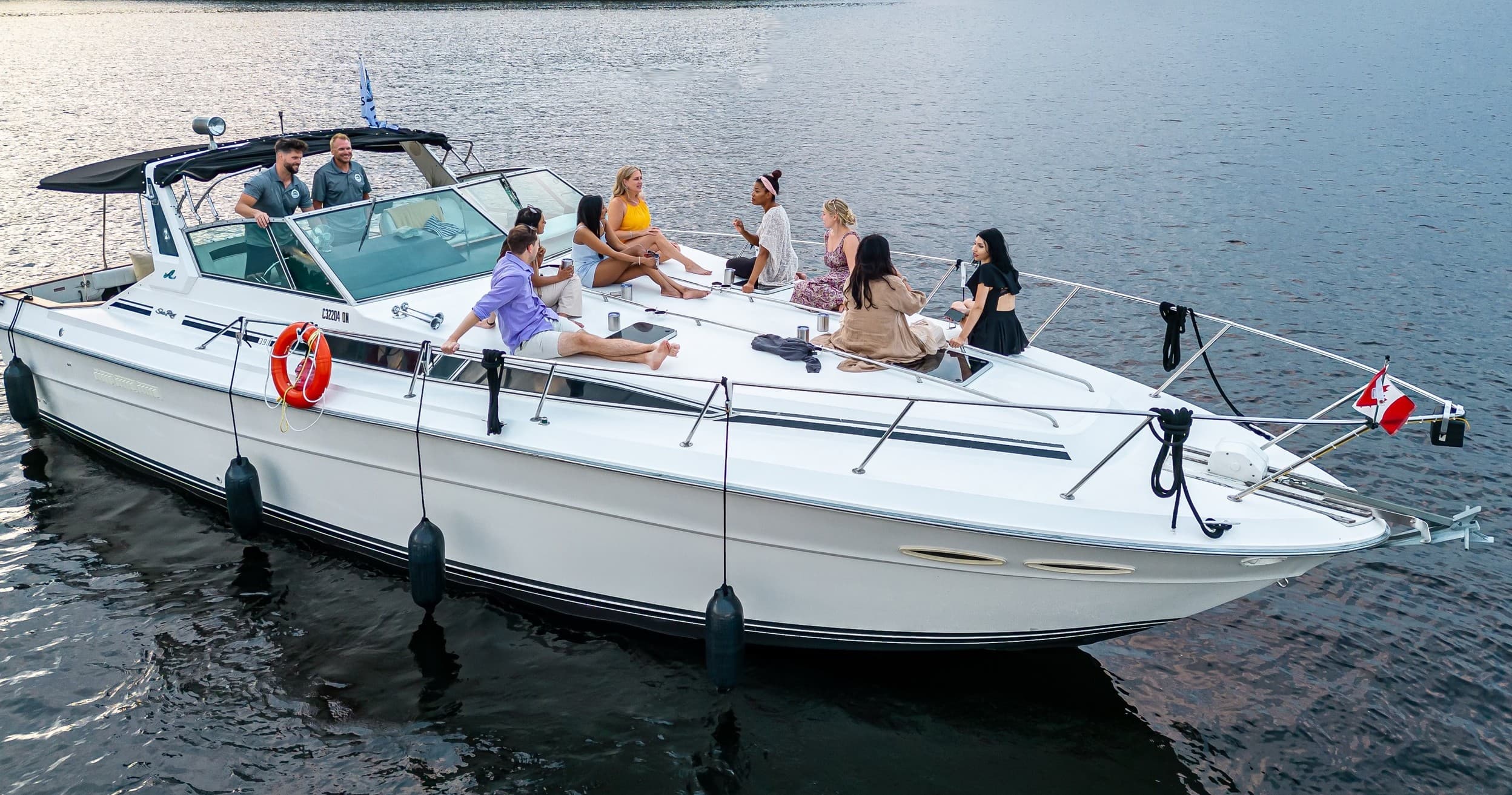 Daytime yacht cruise with passengers relaxing on open deck