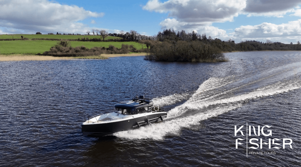 Powered boat skimming lake water past grassy banks and islands
