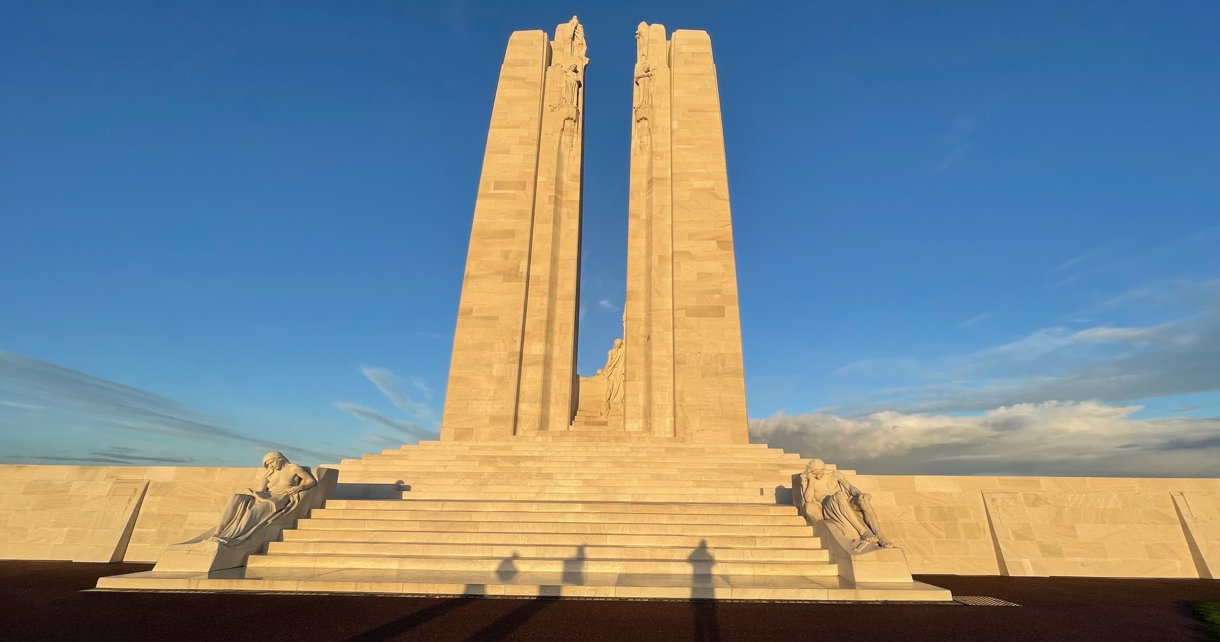 Vimy Ridge memorial monument at sunrise on open battlefield