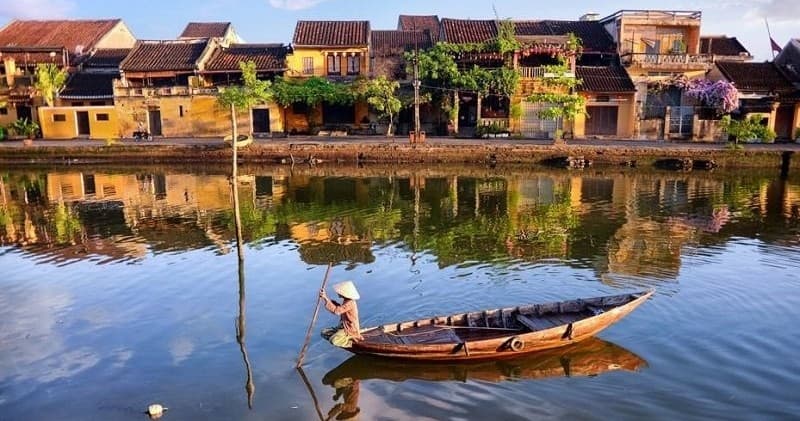 Local boat on tranquil riverfront in historic Hoi An town