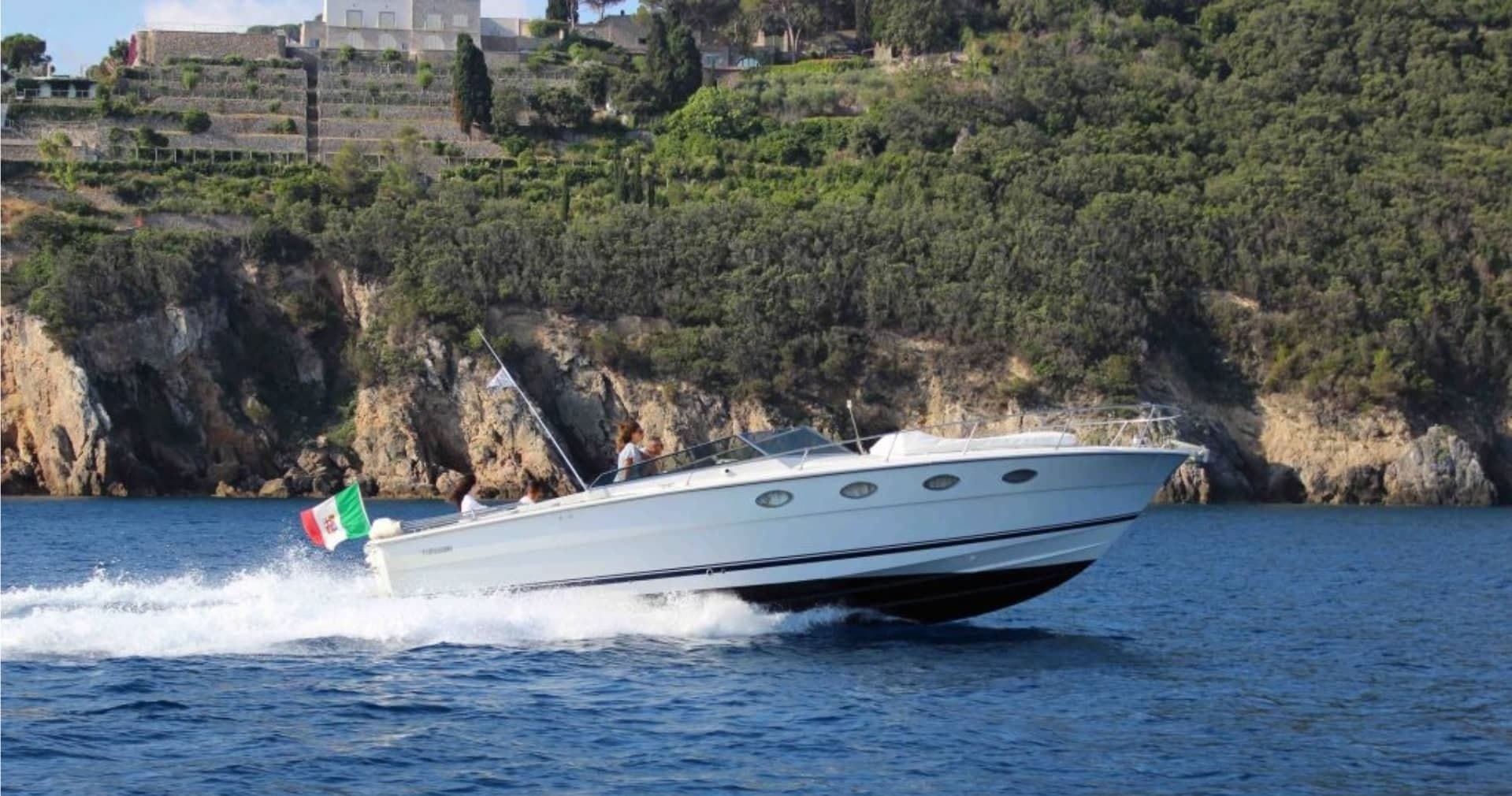 High-speed powerboat slicing through blue coastal waters