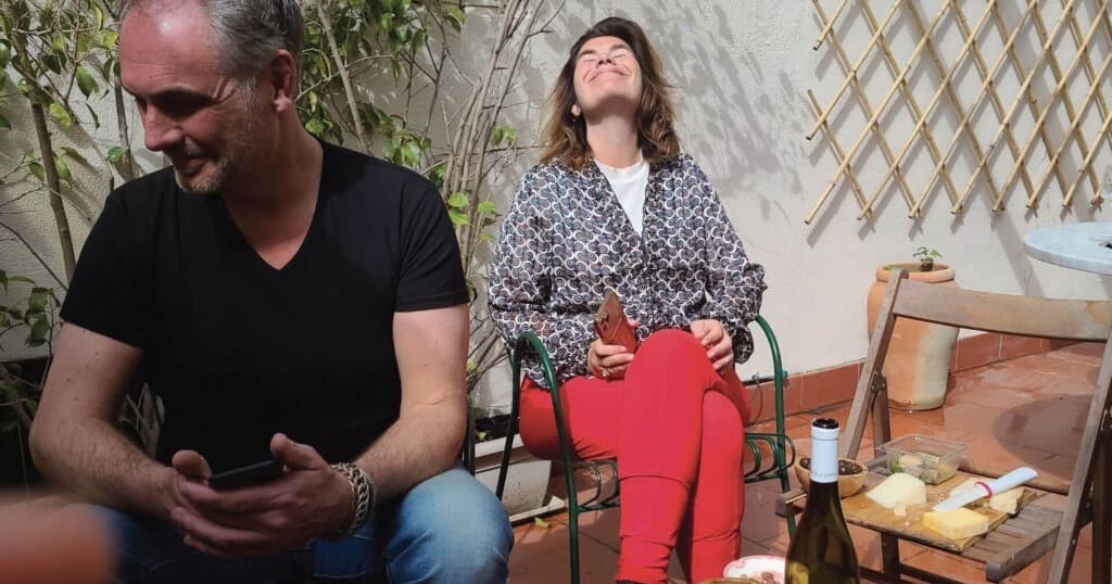 Relaxed guests enjoying sunny outdoor Sicilian courtyard seating