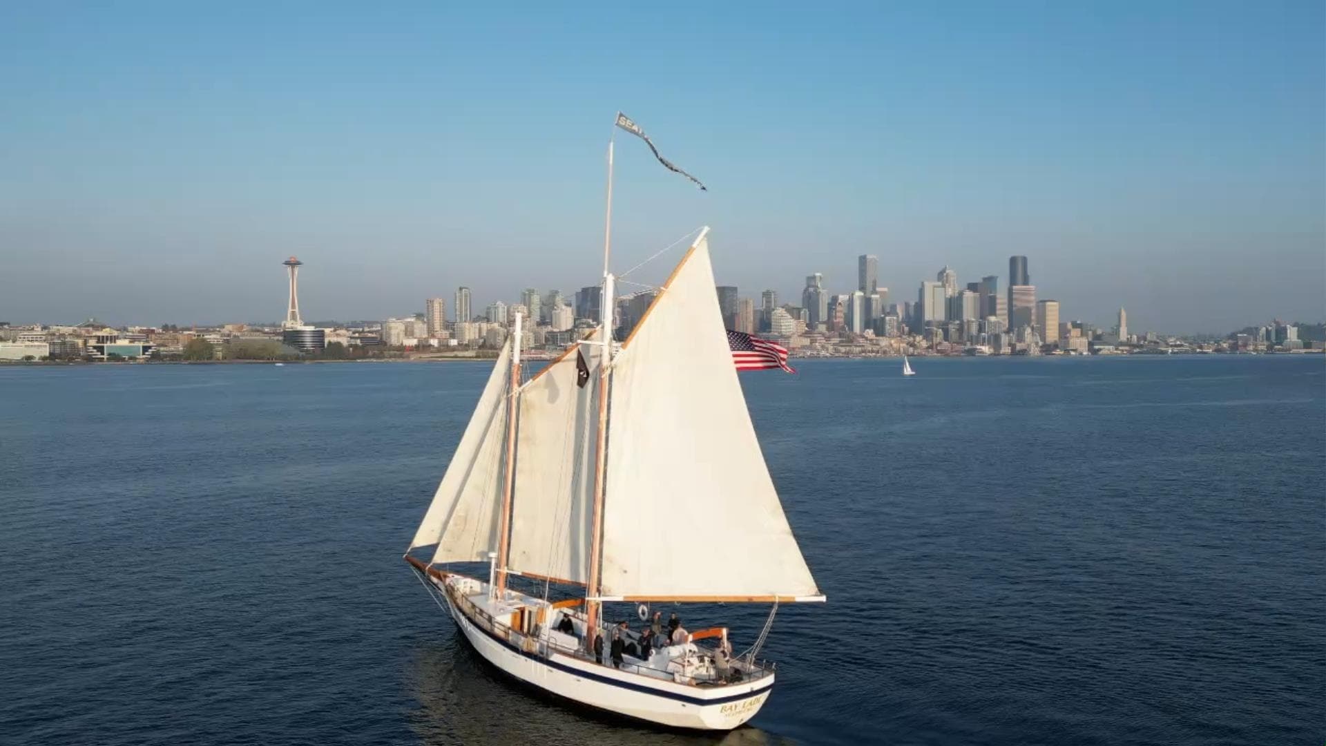 Sailing schooner cruising Puget Sound with Seattle skyline