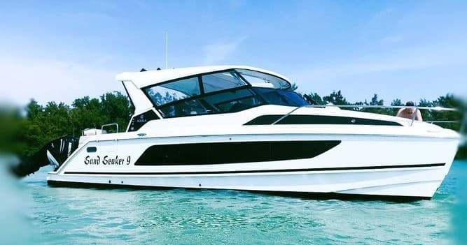 White luxury yacht cruising on clear tropical waters for private charter