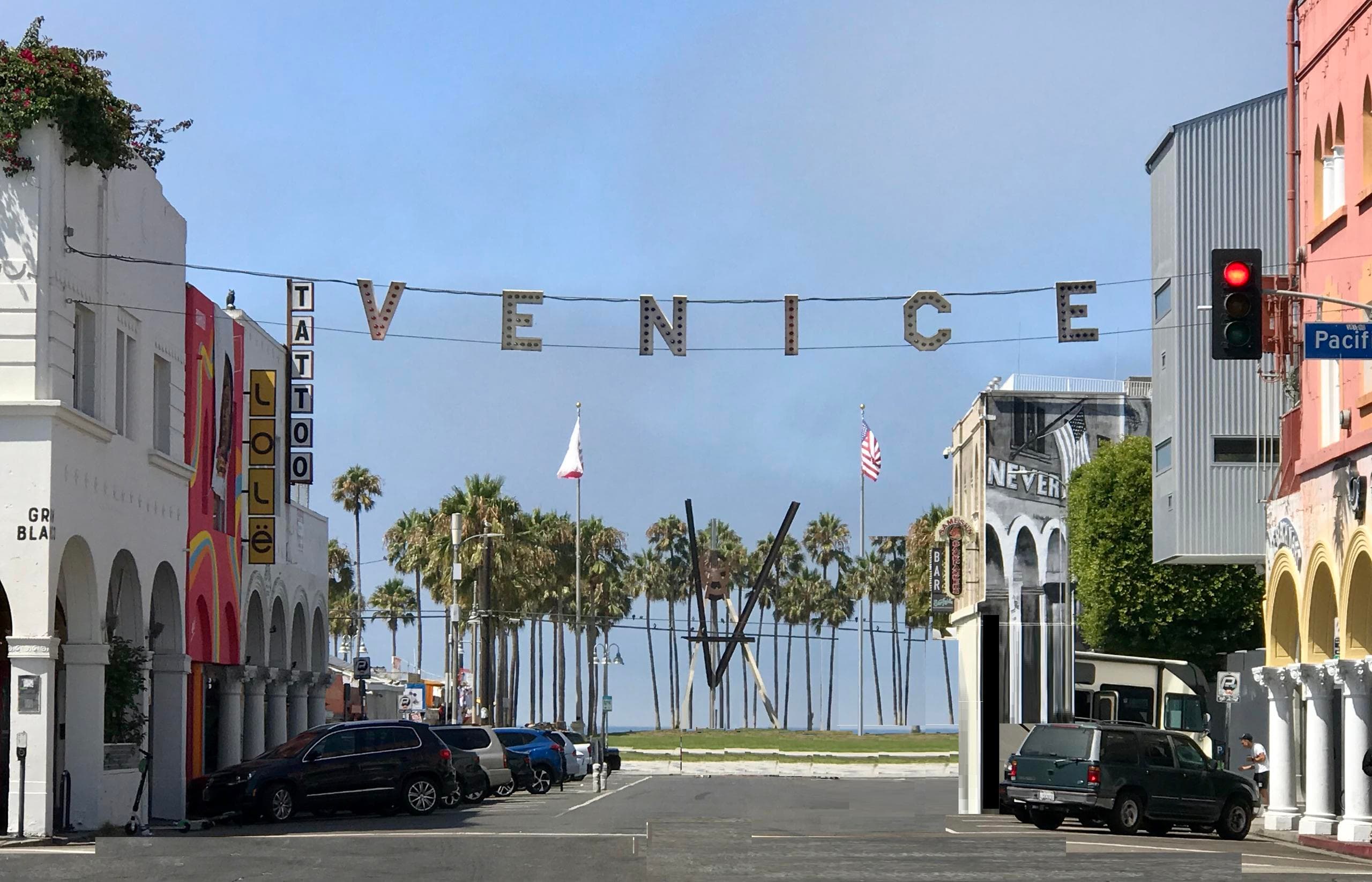 Venice Beach Pacific Avenue with iconic VENICE sign and palm trees