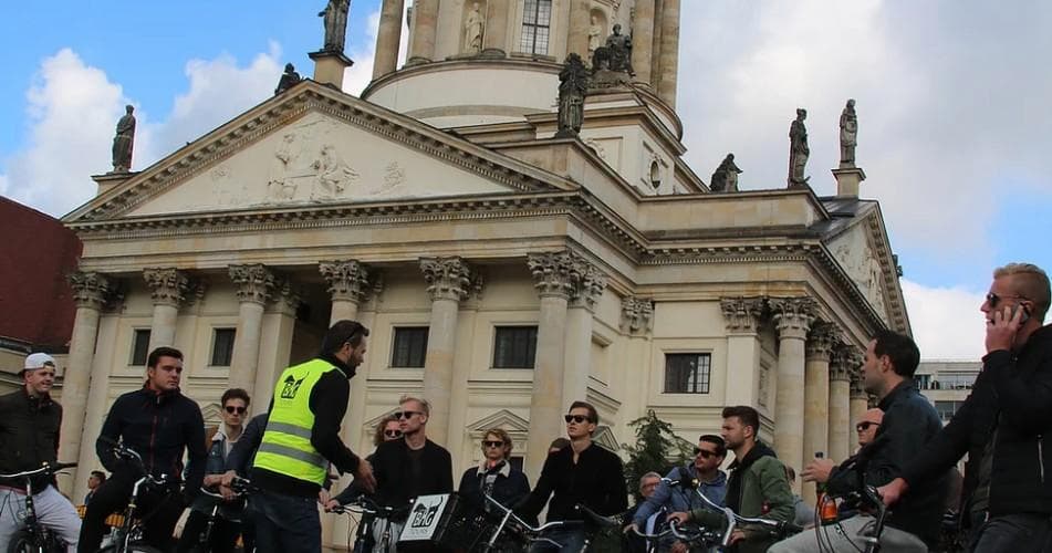 Bike tour group in front of historic cathedral on Berlin square