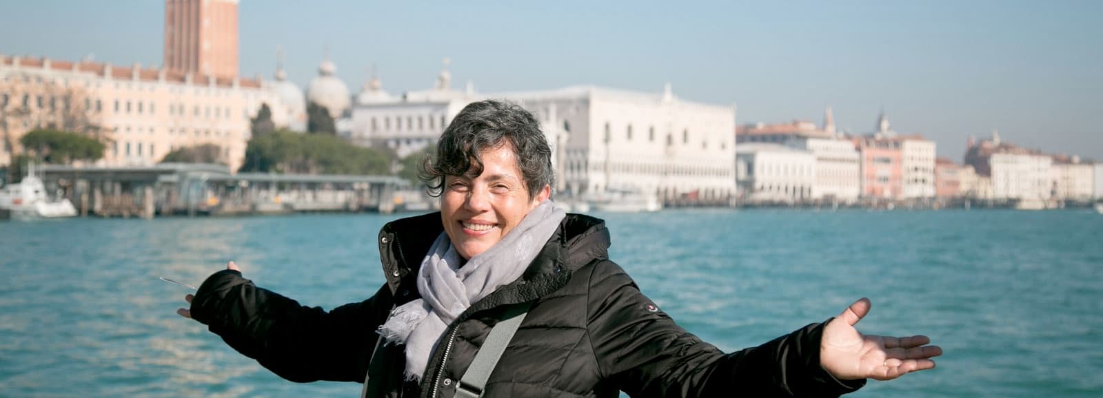 Traveler posing on Venice waterfront with lagoon view experience