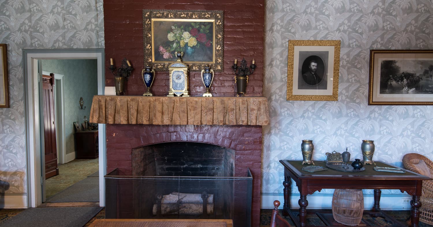 Restored parlor fireplace and period furnishings inside Grant Cottage