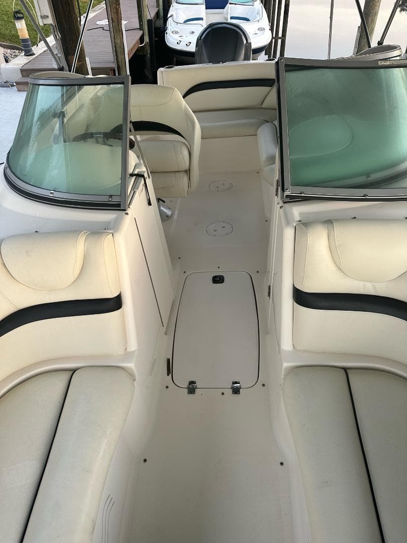 Boat cockpit walkthrough with seating, dry dock interior