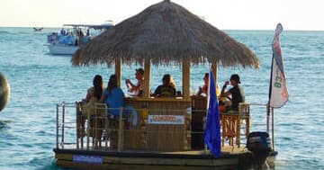 Floating tiki bar boat cruising ocean off Myrtle Beach coast