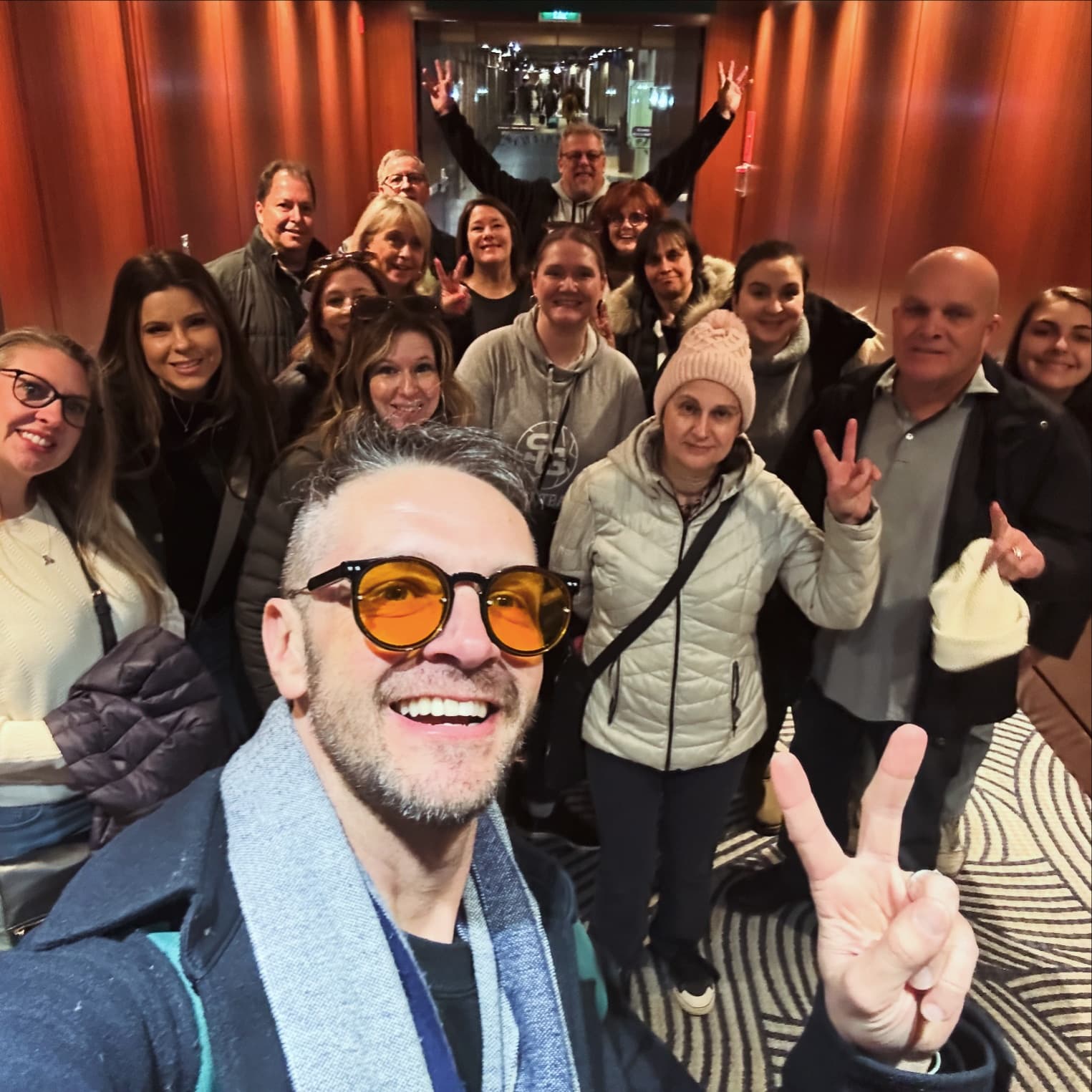 Large group selfie aboard indoor tour in Montreal hotel lobby