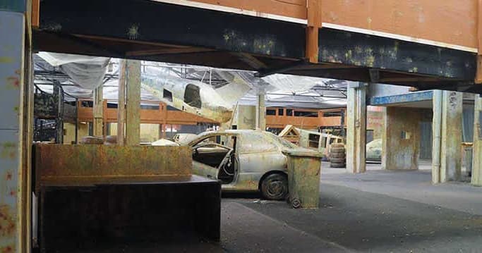 Indoor paintball urban course with cars and multi-level cover