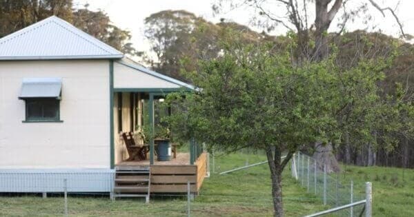 Country cottage and orchard on green pasture, peaceful retreat