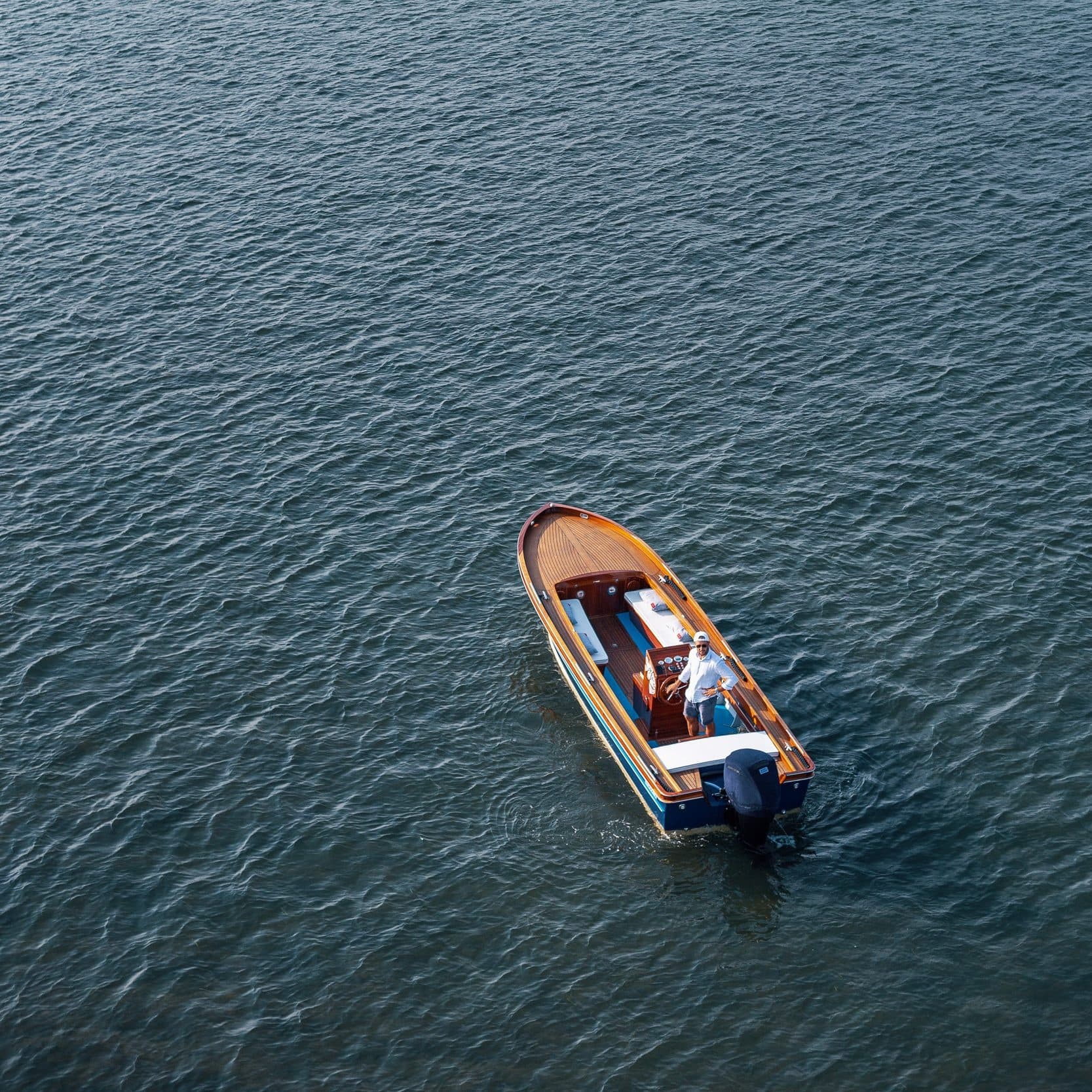 Solitary motorboat on calm Venice lagoon waters, aerial view