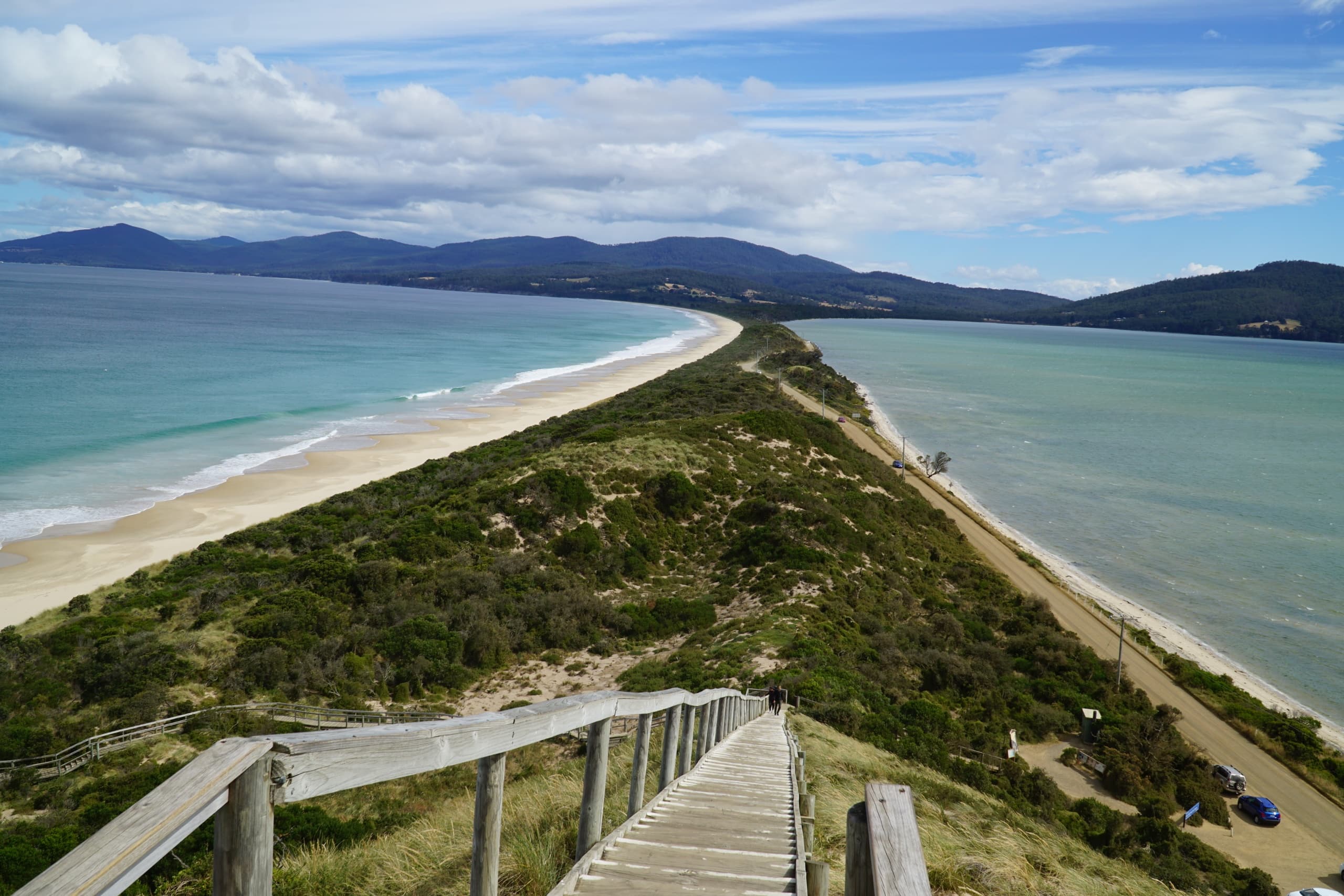 Long coastal sandbar and ocean vistas viewed from wooden walkway Tasmania