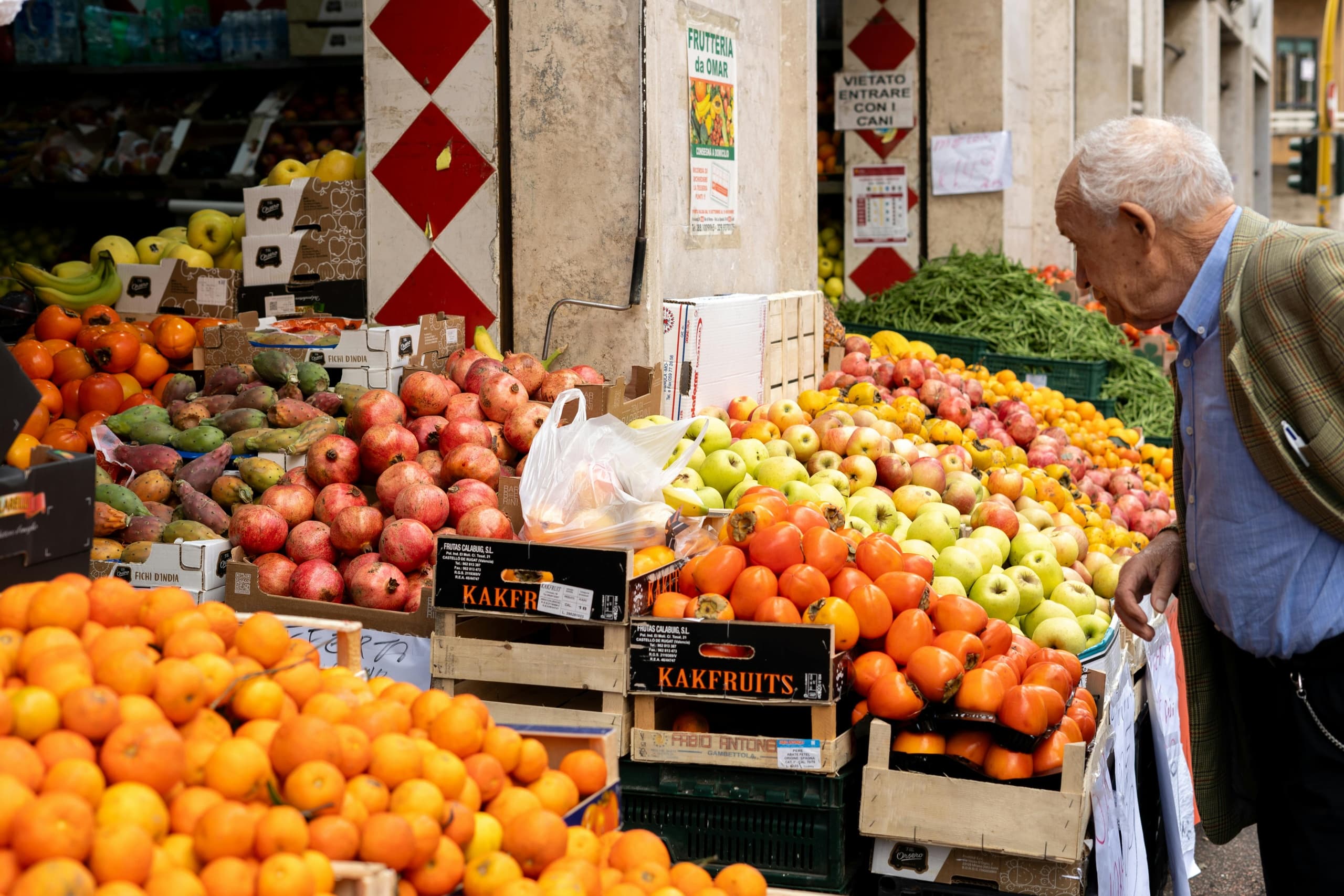 Outdoor Italian produce market stall with fresh fruit display