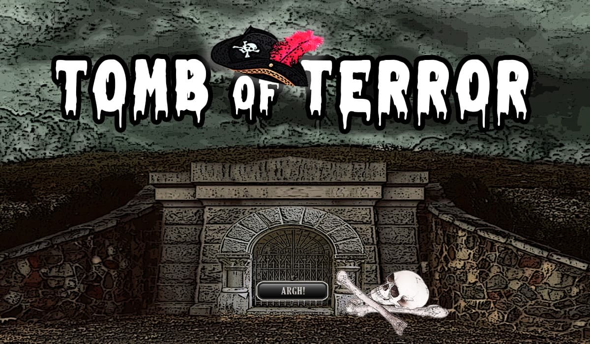 Haunted tomb attraction facade with skull props and spooky entrance