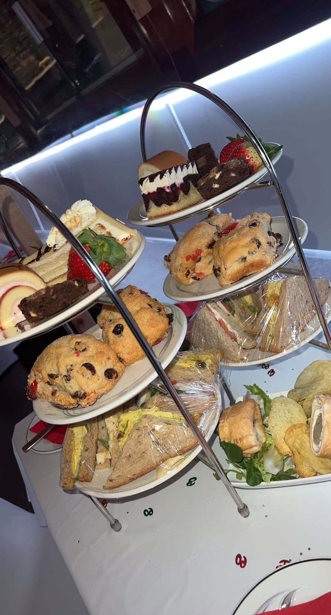 Afternoon tea tray with scones and sandwiches at cafe
