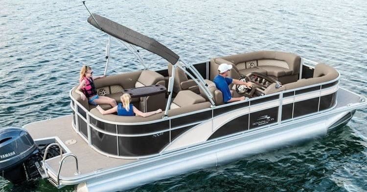 Pontoon boat cruising on clear lake waters with relaxed passengers