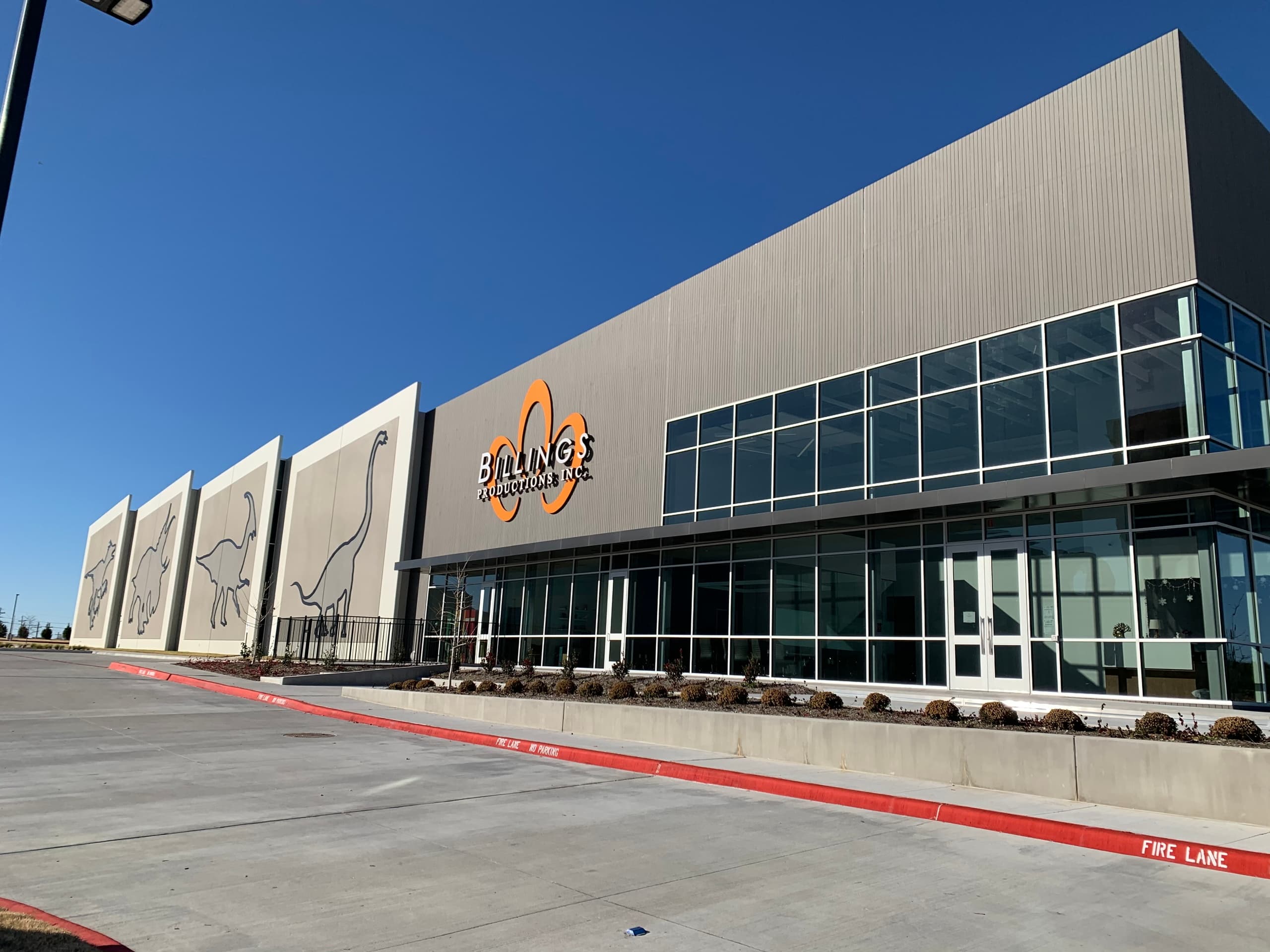 Exterior of large event center venue under clear blue sky