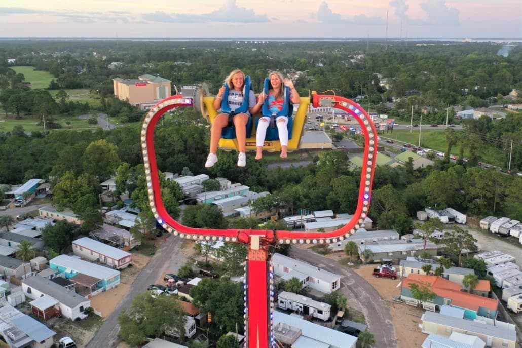 Aerial view of two riders on slingshot over coastal neighborhood