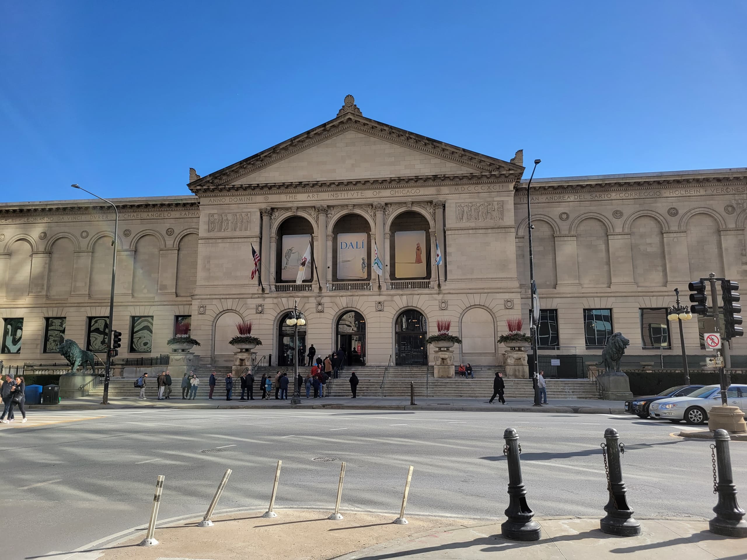 Visitors outside neoclassical museum facade at Chicago plaza