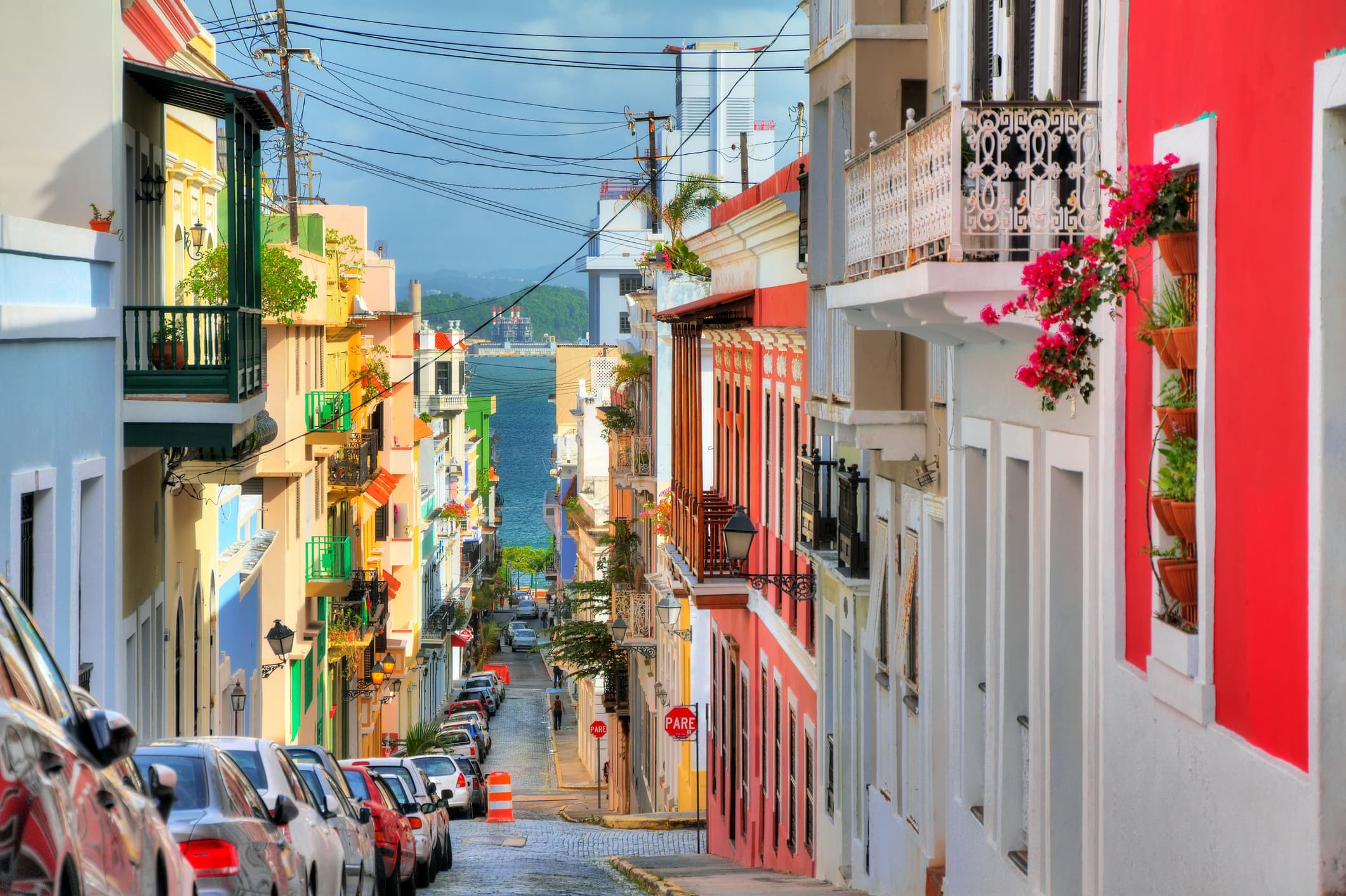 Colorful colonial street sloping to sea for walking and tours