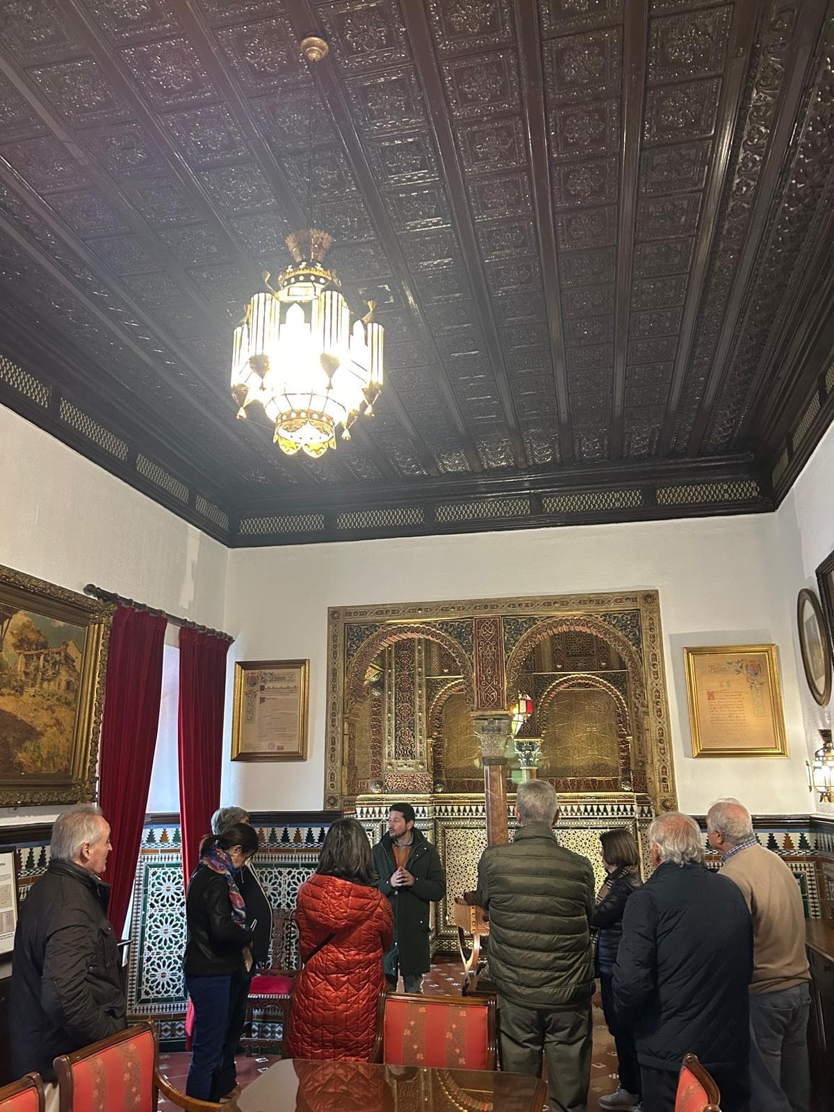 Guided cultural tour inside historic tiled room and exhibits