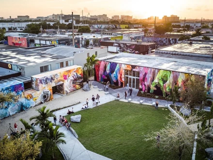Outdoor urban art courtyard with murals, festival lawn scene