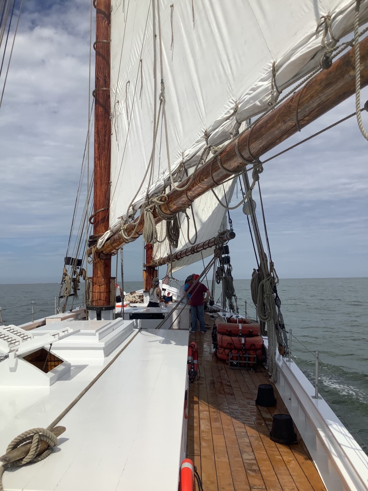 View along schooner deck and rigging during coastal sailing trip