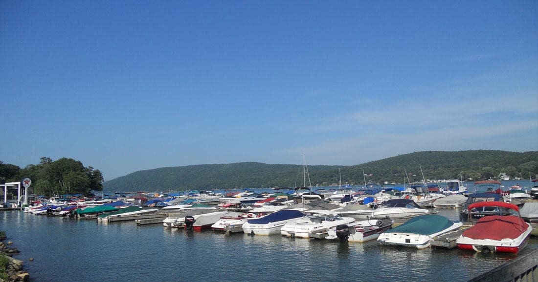 Marina full of moored boats along scenic lakeshore panorama