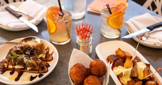 Assorted appetizers and cocktails on a Healdsburg food tour table
