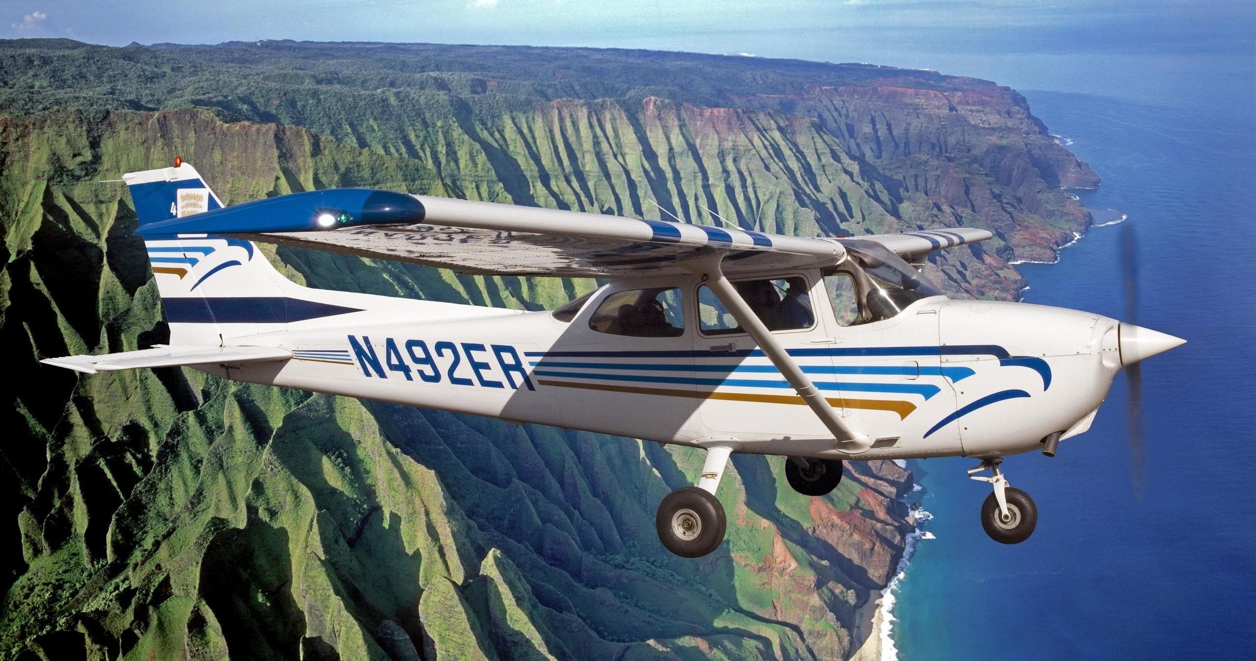 Cessna flight over Na Pali coast on Kauai showcasing rugged cliffs
