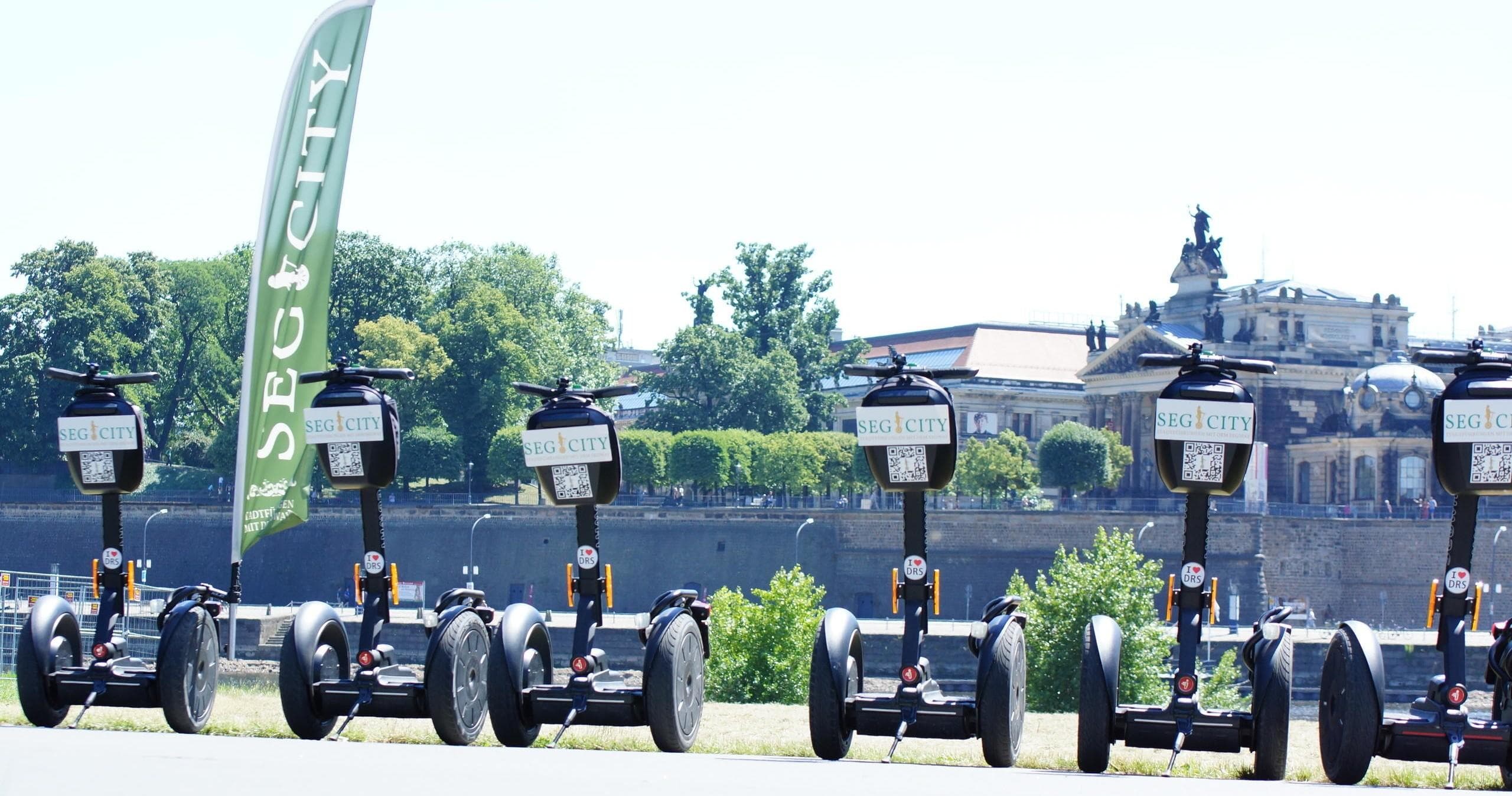 Row of parked Segways by riverfront ready for guided city tours