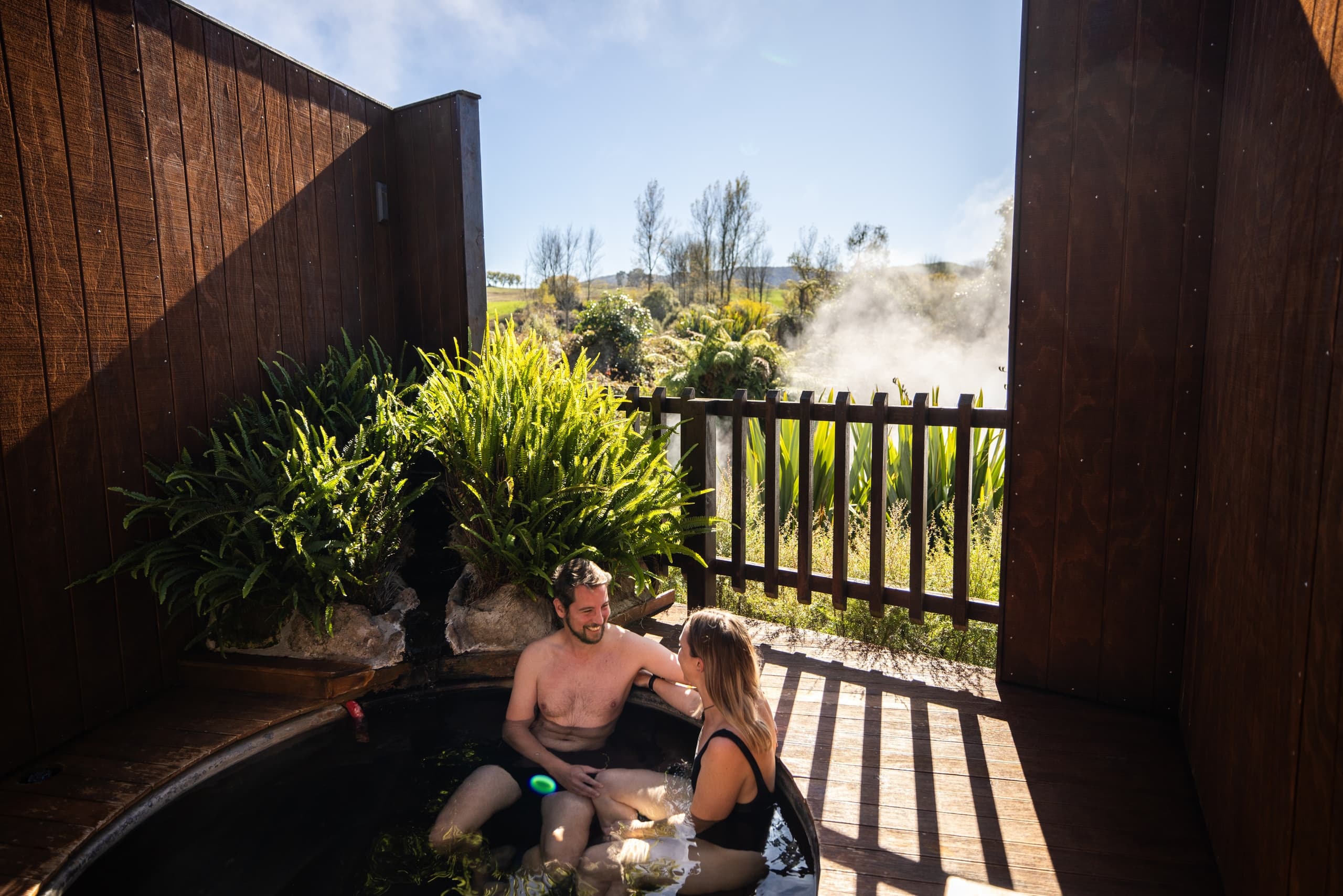 Couple relaxing in private outdoor hot tub with view