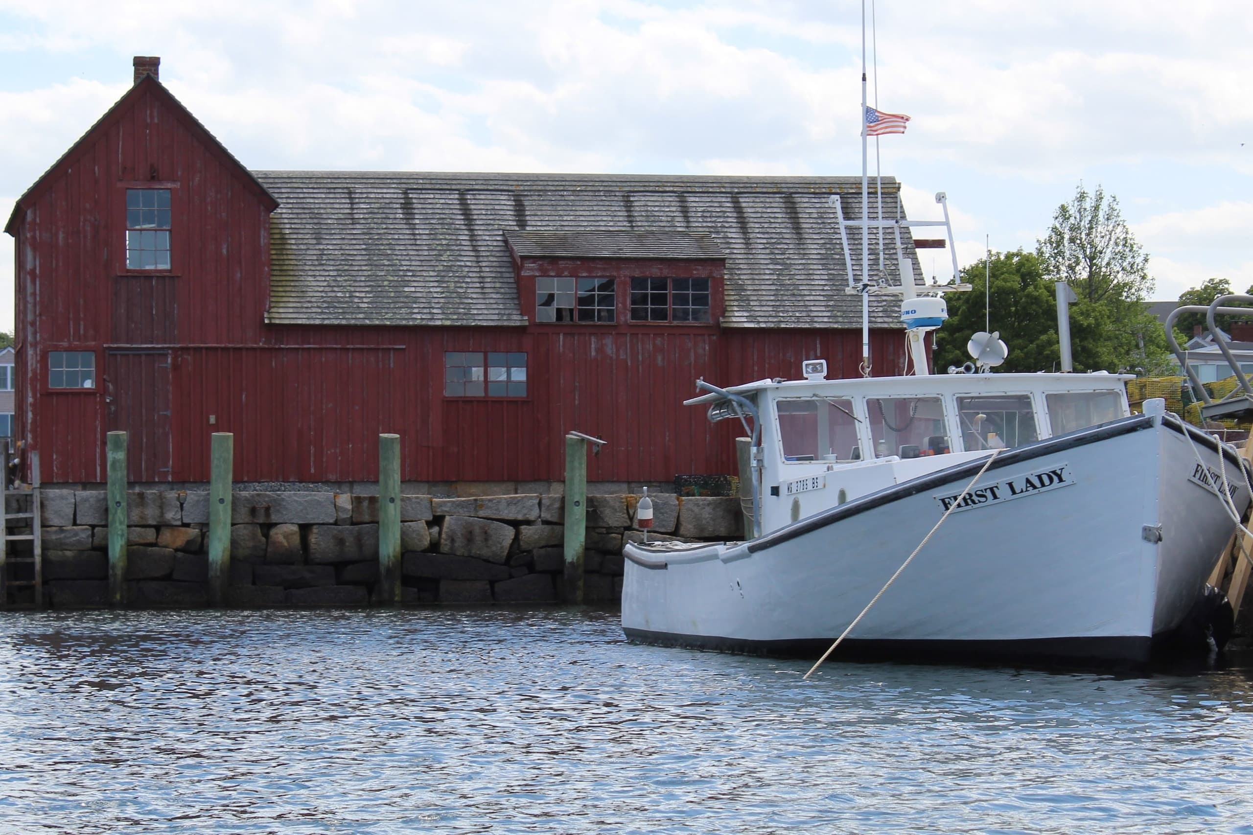 Coastal charter fishing boat docked at New England harbor