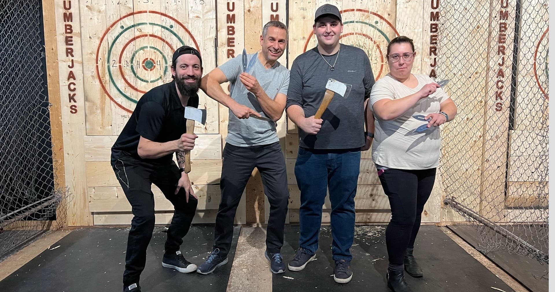 Friends celebrating after indoor axe throwing at Lumberjacks Niagara