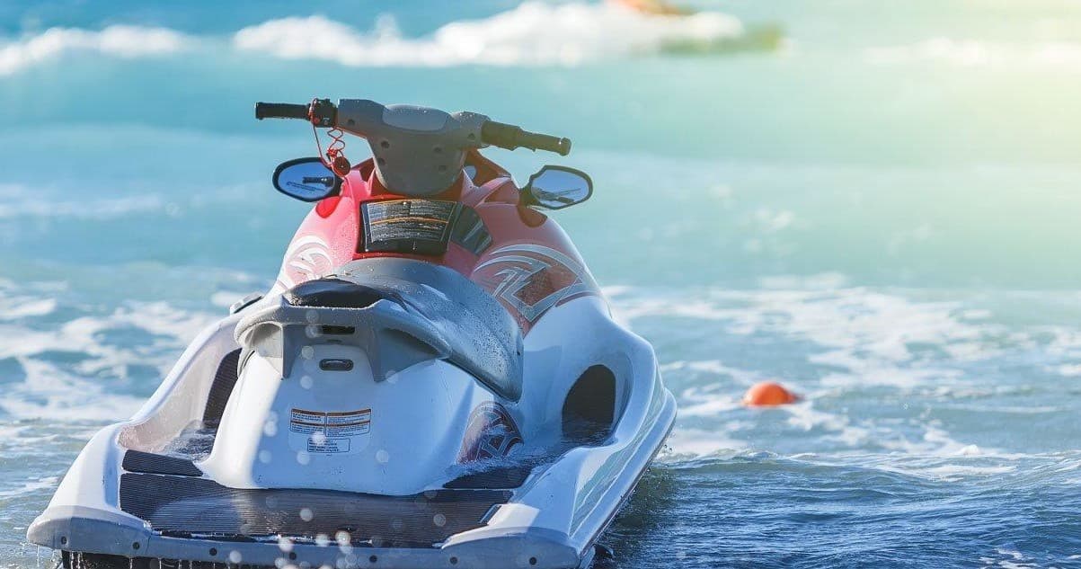 Jet ski on choppy ocean water with sunny coastal horizon