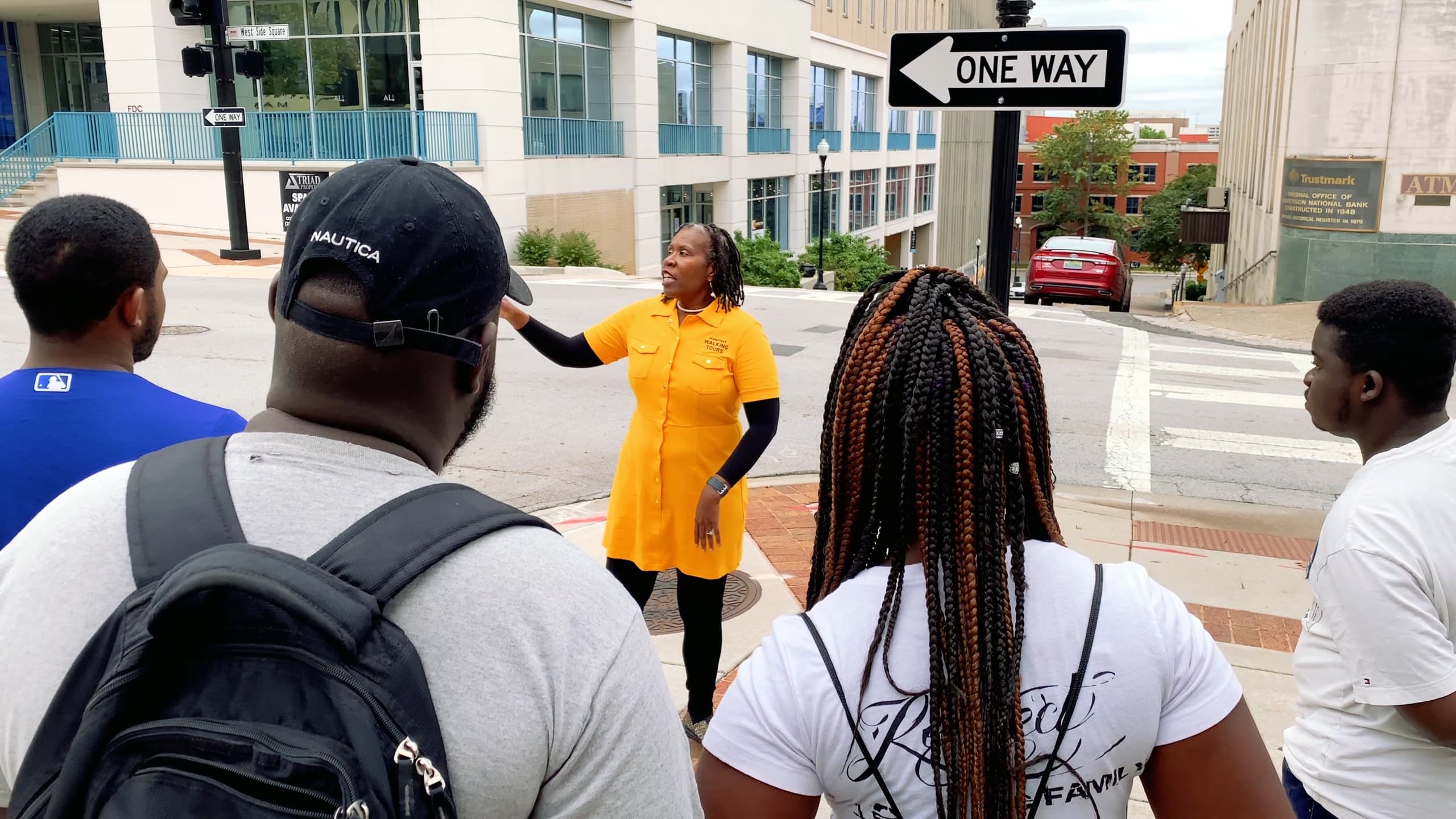 Urban walking tour with guide pointing out city landmarks
