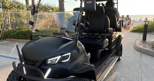 Black golf cart rental parked by Indian Rocks Beach promenade