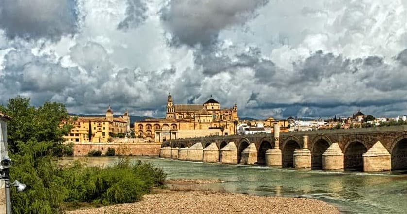 Sunlit Roman bridge over Guadalquivir River in Córdoba
