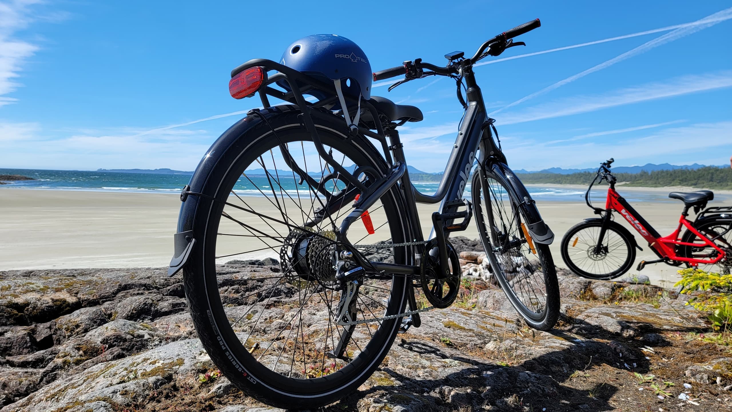 Bicycles parked on rocky beach with ocean horizon view
