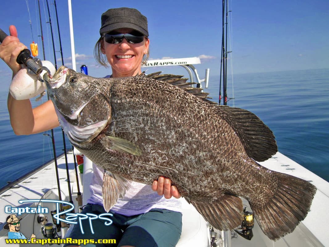 Angler holding trophy reef fish aboard a nearshore fishing charter