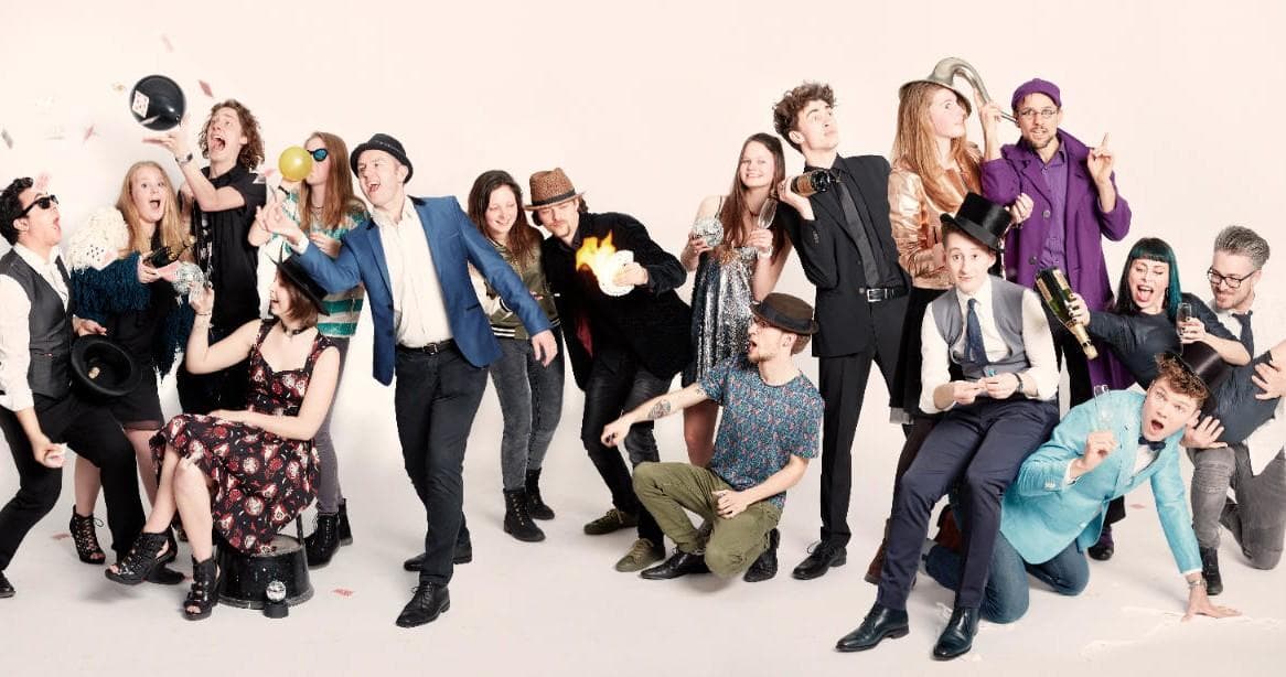 Large ensemble of magicians posing in studio for Amsterdam show