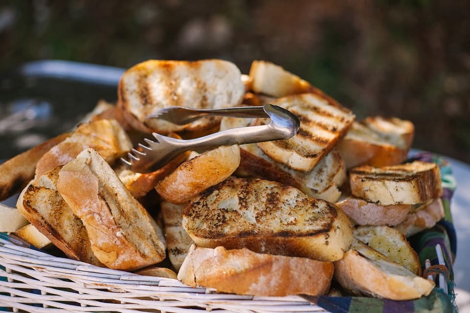 Grilled bread slices served in basket during outdoor boat picnic
