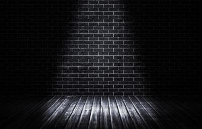 Dark illuminated brick stage interior, moody theatrical backdrop