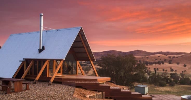 A-frame cabin at sunset in rural hills offering remote stay