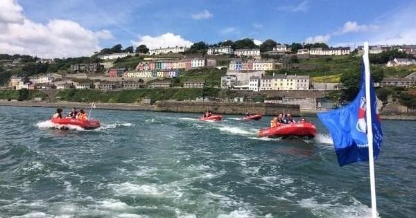 RIB speedboats cruising Cork Harbour coastline with passengers